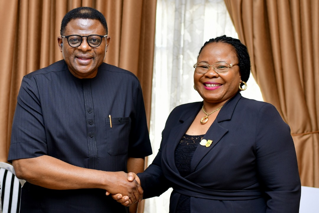 L-R: Sen. Bassey Otu, Governor of Cross River State in a handshake with Mrs Roseline Izuagbe, State Director of the Department of State Services, DSS, Cross River State Command
