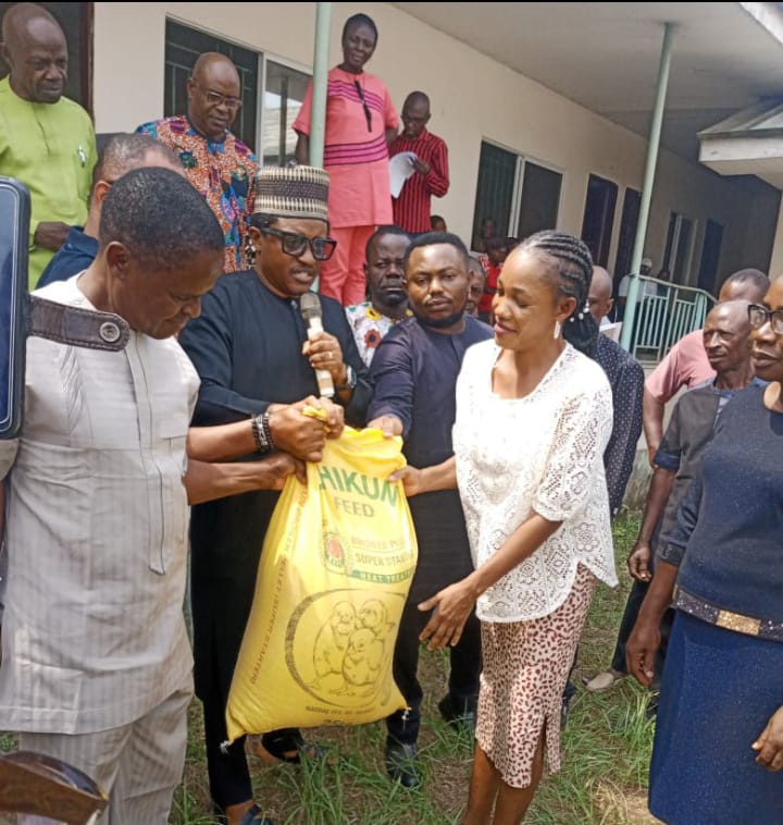 One of the beneficiaries receiving a bag of poultry feed from Cross River's Commissioner for Agriculture and Irrigation Development, Hon. Johnson Ebokpo