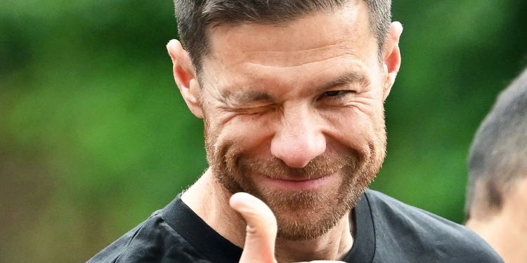 Leverkusen coach Xabi Alonso gestures during a motorcade from Morsbroich Castle to the BayArena. Champions Bayer Leverkusen open the 62nd Bundesliga season at regional rivals Borussia Mönchengladbach on August 23, and also face runners-up VfB Stuttgart and Bayern Munich early on. Credit: Marius Becker/dpa