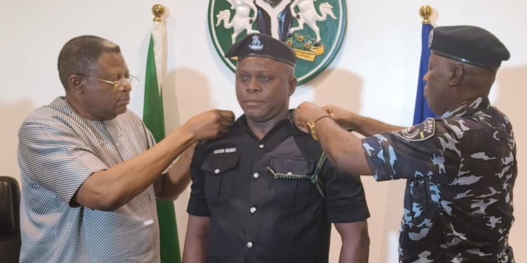 L-R: Cross River State Governor, Sen. Prince Bassey Otu, one of the newly promoted officers, ASP Victor Reuben, Cross River State Commissioner of Police, CP Gyogon Augustine Grimah.