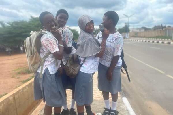 Secondary school students sign out 4 Secondary school students sign out on uniforms after completing WAEC