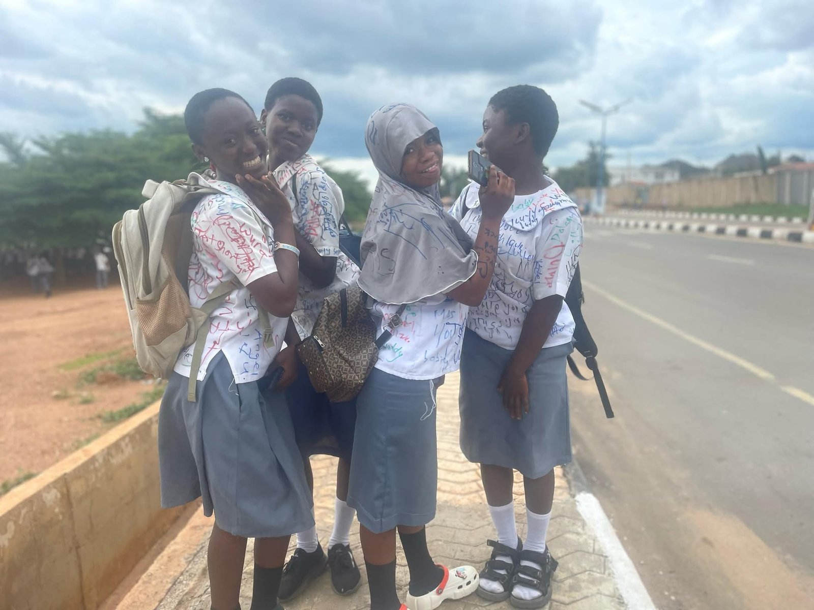 Secondary school students sign out 4 Secondary school students sign out on uniforms after completing WAEC